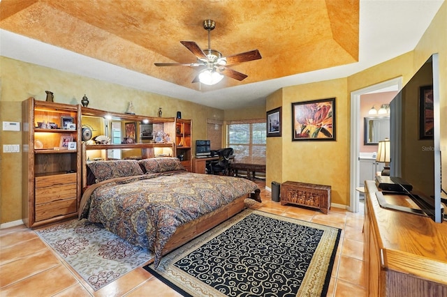 1714 Sweetwater W Cir, Apopka, FL 32712 - bedroom featuring a raised ceiling, ensuite bath, baseboards, and light tile patterned floors