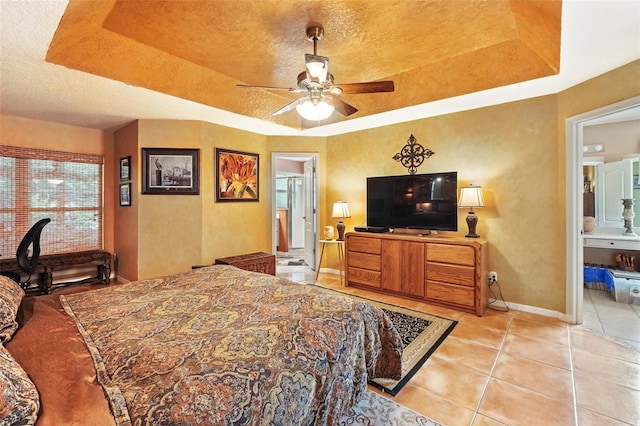 1714 Sweetwater W Cir, Apopka, FL 32712 - bedroom with a raised ceiling, baseboards, ensuite bathroom, and light tile patterned floors