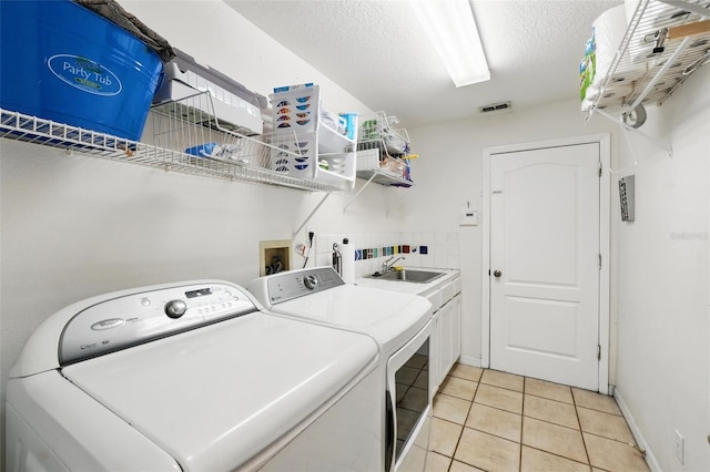 1714 Sweetwater W Cir, Apopka, FL 32712 - laundry area with visible vents, light tile patterned floors, a sink, independent washer and dryer, and cabinet space