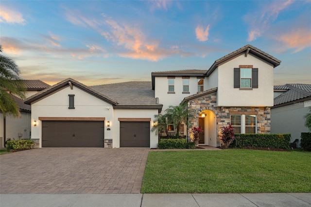 8017 Chilton Dr, Orlando, FL 32836 - view of front of property with stone siding, decorative driveway, stucco siding, and a garage
