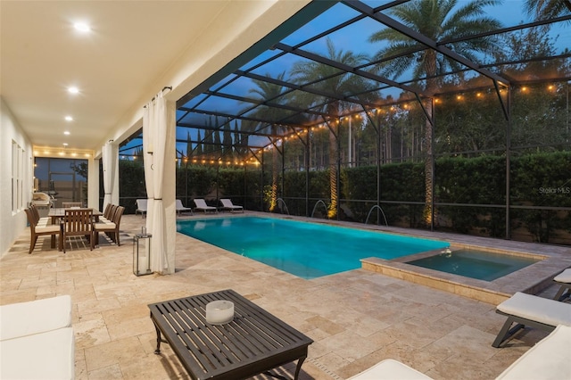 8017 Chilton Dr, Orlando, FL 32836 - outdoor pool with an in-ground hot tub, a patio, glass enclosure, and outdoor dining area