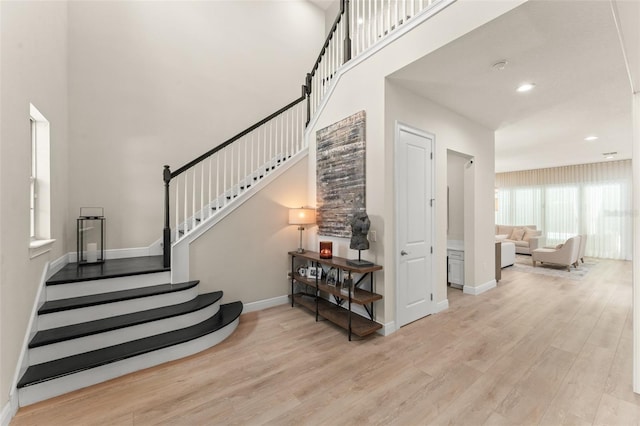 8017 Chilton Dr, Orlando, FL 32836 - stairs with wood finished floors, baseboards, a high ceiling, and recessed lighting