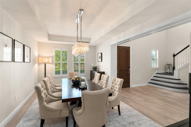8017 Chilton Dr, Orlando, FL 32836 - dining space featuring a chandelier, stairs, light wood-type flooring, and plenty of natural light