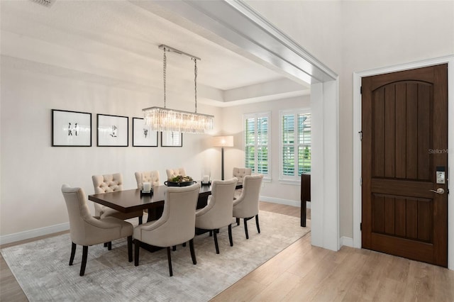 8017 Chilton Dr, Orlando, FL 32836 - dining room with light wood-style flooring, a chandelier, baseboards, and rail lighting