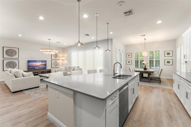 8017 Chilton Dr, Orlando, FL 32836 - kitchen featuring a sink, stainless steel dishwasher, light wood-type flooring, a center island with sink, and open floor plan