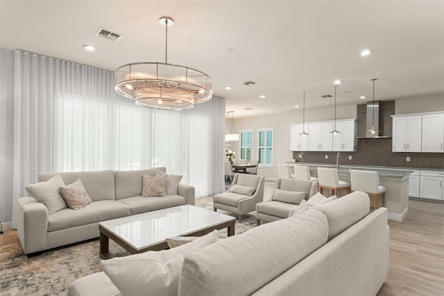 8017 Chilton Dr, Orlando, FL 32836 - living room featuring recessed lighting, light wood-style flooring, and a chandelier