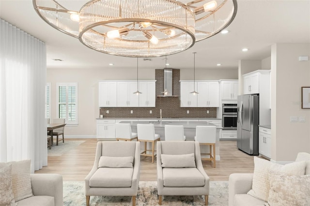8017 Chilton Dr, Orlando, FL 32836 - living room featuring light wood-style floors, a chandelier, and recessed lighting