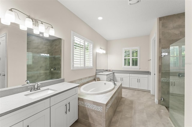 8017 Chilton Dr, Orlando, FL 32836 - full bathroom featuring plenty of natural light, a shower stall, a garden tub, tile patterned floors, and recessed lighting