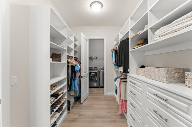 8017 Chilton Dr, Orlando, FL 32836 - spacious closet featuring washing machine and clothes dryer and light wood-style floors
