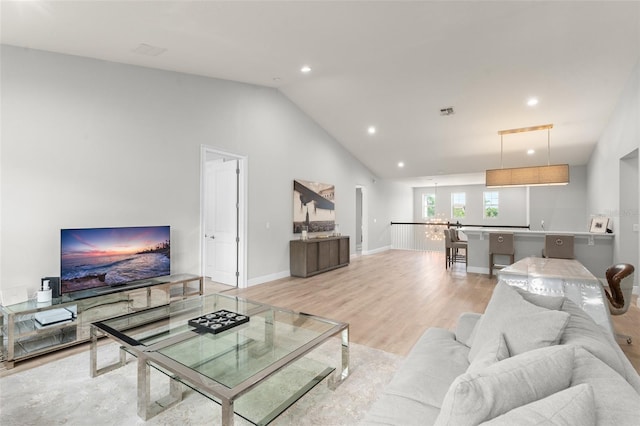 8017 Chilton Dr, Orlando, FL 32836 - living room featuring lofted ceiling, recessed lighting, light wood-type flooring, and baseboards