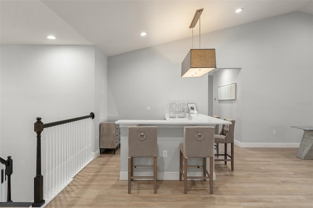8017 Chilton Dr, Orlando, FL 32836 - kitchen featuring a kitchen breakfast bar, lofted ceiling, light wood-style floors, recessed lighting, and a peninsula