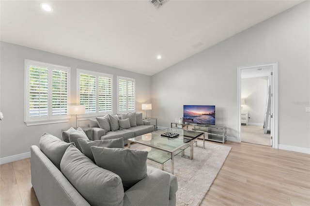 8017 Chilton Dr, Orlando, FL 32836 - living area with vaulted ceiling, baseboards, light wood finished floors, and recessed lighting