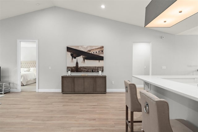 8017 Chilton Dr, Orlando, FL 32836 - bar with lofted ceiling, light wood finished floors, baseboards, and recessed lighting