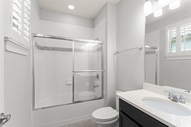 8017 Chilton Dr, Orlando, FL 32836 - full bathroom featuring toilet, vanity, combined bath / shower with glass door, tile patterned flooring, and recessed lighting