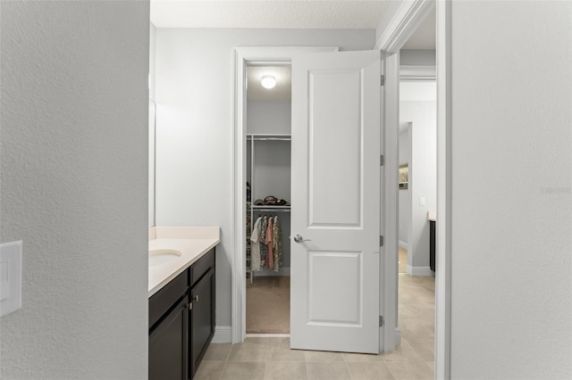 8017 Chilton Dr, Orlando, FL 32836 - bathroom with tile patterned flooring, vanity, and a spacious closet