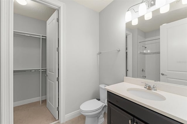 8017 Chilton Dr, Orlando, FL 32836 - bathroom featuring a shower, a spacious closet, toilet, vanity, and baseboards