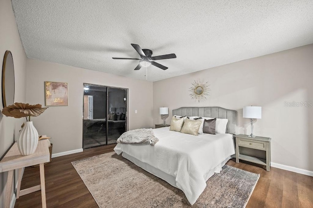 bedroom with baseboards, wood finished floors, a textured ceiling, and access to exterior