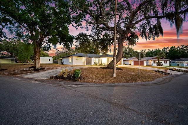 single story home with driveway and an attached garage