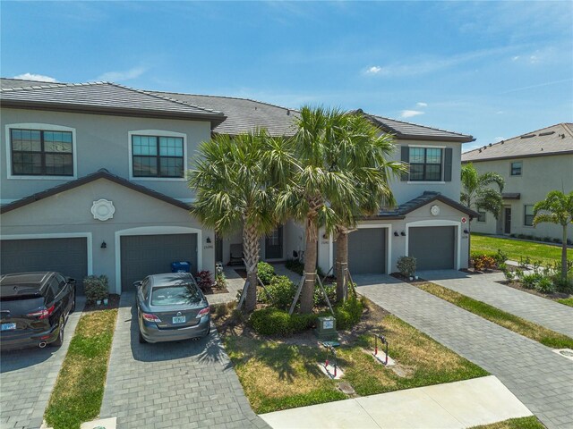 15242 Sunny Day Dr, Bradenton, FL 34211 - view of front of house with driveway, stucco siding, and a garage