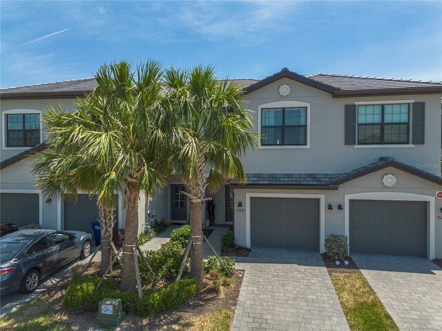 15242 Sunny Day Dr, Bradenton, FL 34211 - townhome / multi-family property with stucco siding, driveway, and an attached garage
