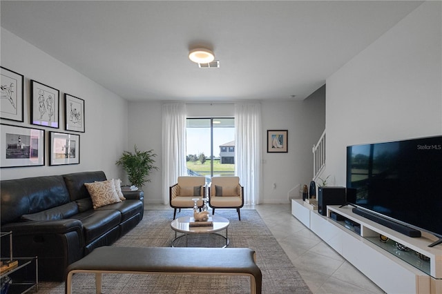 15242 Sunny Day Dr, Bradenton, FL 34211 - living room with light tile patterned flooring, visible vents, and stairs
