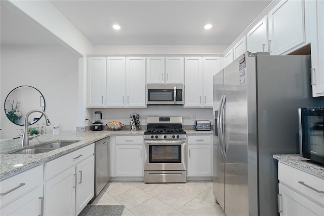 15242 Sunny Day Dr, Bradenton, FL 34211 - kitchen featuring white cabinetry, stainless steel appliances, light tile patterned flooring, and a sink
