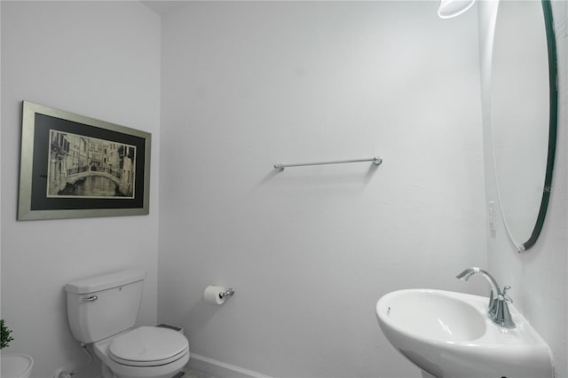 15242 Sunny Day Dr, Bradenton, FL 34211 - half bathroom featuring toilet, baseboards, and a sink