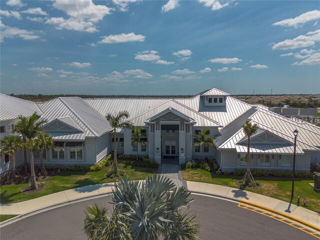15242 Sunny Day Dr, Bradenton, FL 34211 - exterior space featuring a standing seam roof, french doors, and metal roof