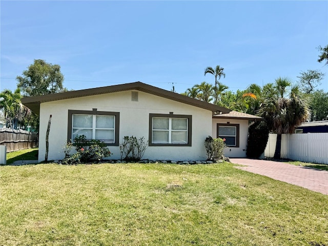 3735 Alabama Ave NE, Saint Petersburg, FL 33703 - ranch-style house featuring fence, stucco siding, and a front lawn