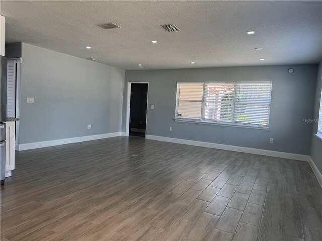 3735 Alabama Ave NE, Saint Petersburg, FL 33703 - spare room with recessed lighting, dark wood-type flooring, visible vents, baseboards, and a textured ceiling