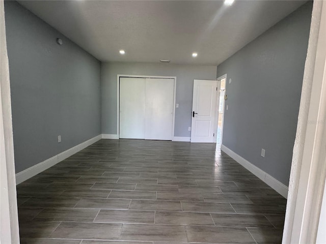 3735 Alabama Ave NE, Saint Petersburg, FL 33703 - unfurnished bedroom featuring baseboards, recessed lighting, wood tiled floor, and a closet