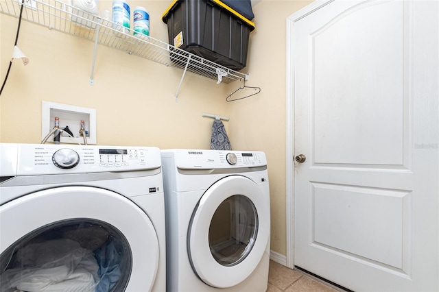 laundry room with light tile patterned floors, laundry area, and washing machine and clothes dryer