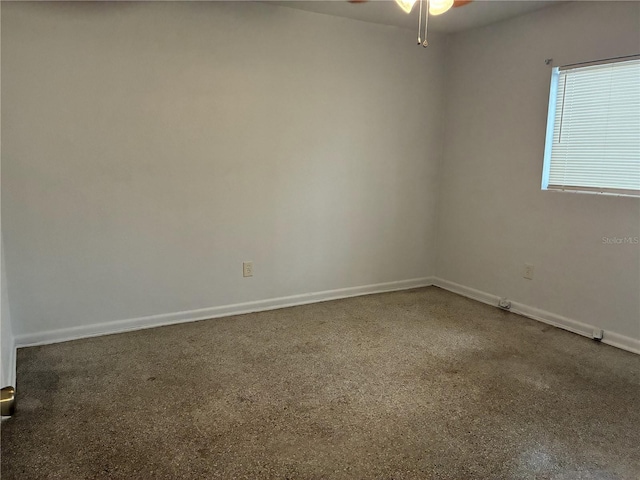 empty room featuring baseboards and ceiling fan