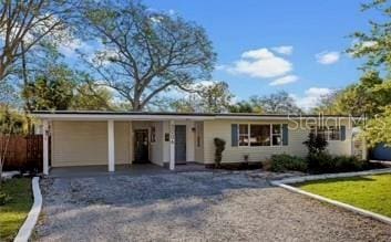 3006 Northwood Blvd, Winter Park, FL 32789 - ranch-style home with a carport, gravel driveway, and fence