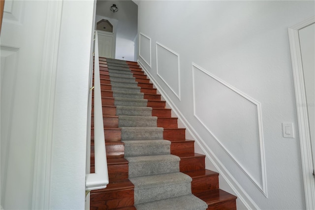 7613 Bay Port Rd Unit 34, Orlando, FL 32819 - staircase featuring wood finished floors
