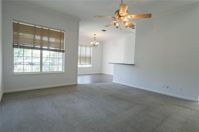 7613 Bay Port Rd Unit 34, Orlando, FL 32819 - spare room with crown molding, visible vents, baseboards, carpet floors, and ceiling fan with notable chandelier