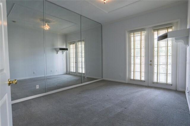 7613 Bay Port Rd Unit 34, Orlando, FL 32819 - carpeted spare room featuring baseboards and ornamental molding