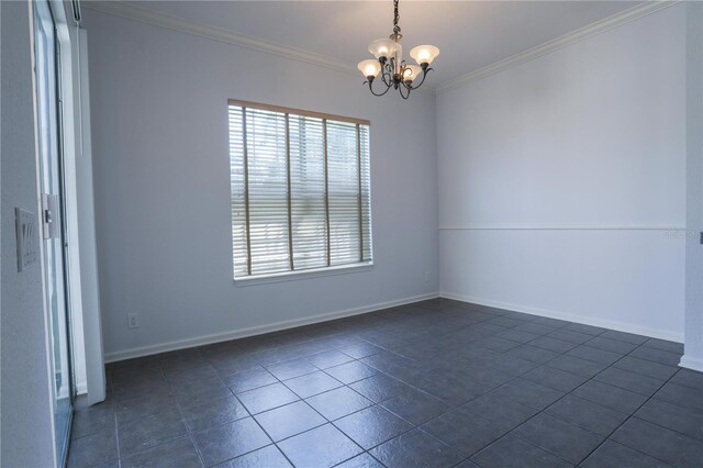 7613 Bay Port Rd Unit 34, Orlando, FL 32819 - spare room with ornamental molding, dark tile patterned floors, a chandelier, and baseboards