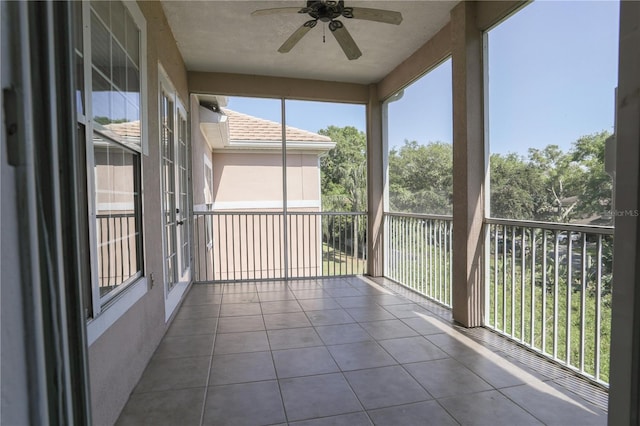 7613 Bay Port Rd Unit 34, Orlando, FL 32819 - unfurnished sunroom with ceiling fan, plenty of natural light, and tile patterned flooring