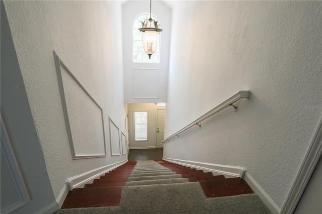 7613 Bay Port Rd Unit 34, Orlando, FL 32819 - stairway featuring a textured wall, wood finished floors, and baseboards