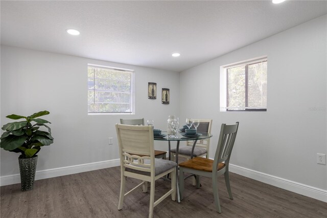 dining area featuring wood finished floors and baseboards