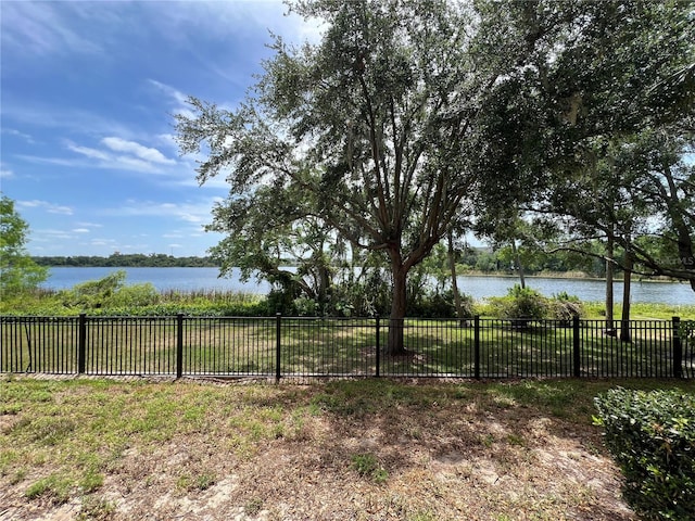 view of yard featuring fence and a water view
