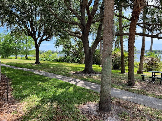 view of property's community featuring a yard and a water view