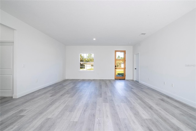 unfurnished room with recessed lighting, baseboards, visible vents, and light wood-style flooring