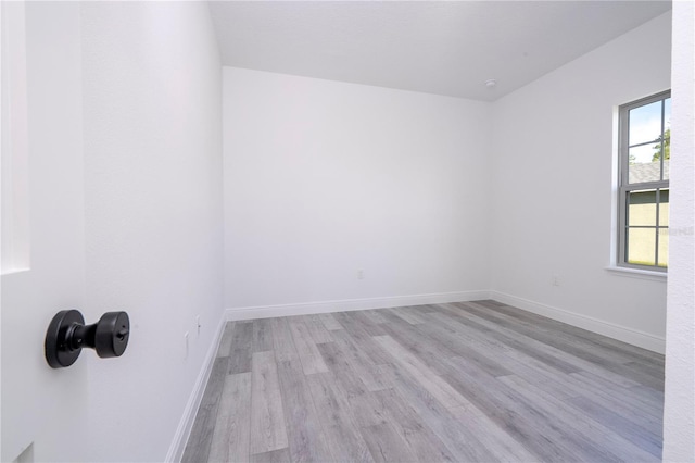 unfurnished room with wood finished floors and baseboards