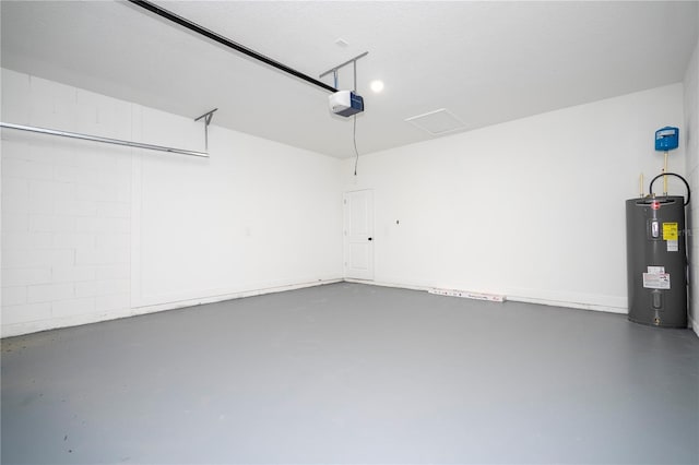 garage featuring a garage door opener and electric water heater