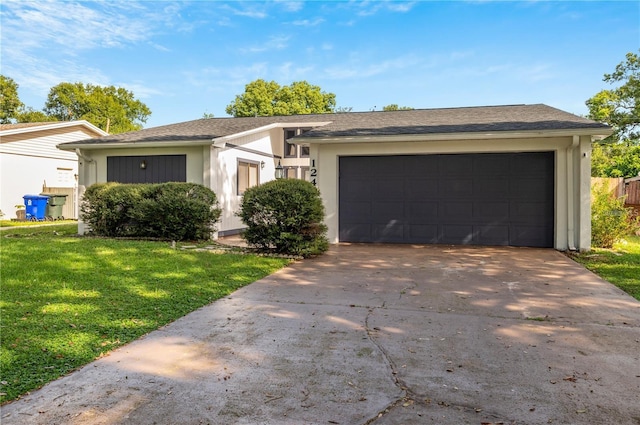 ranch-style house featuring stucco siding, driveway, a front lawn, and a garage