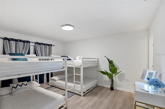bedroom featuring wood finished floors and baseboards