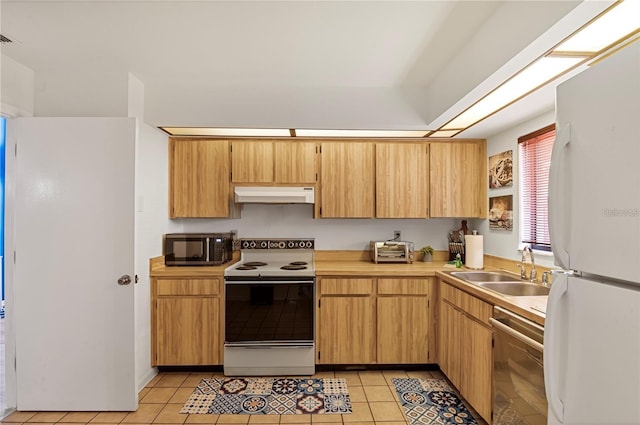 kitchen featuring a sink, white appliances, light tile patterned floors, light countertops, and under cabinet range hood