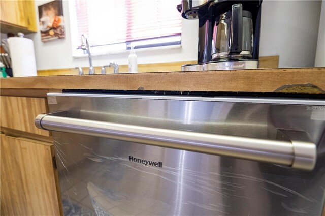 details with stainless steel dishwasher and a sink